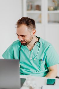 Kaboompics - Stressed Doctor Adjusting Glasses at Medical Desk