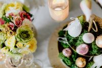 Kaboompics - Overhead Spring Easter Table with Floral Arrangement, Candle and Moss Egg Display