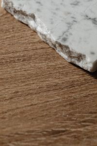 Kaboompics - Rough Marble Slab Edge Against Natural Wood Texture