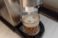 Kaboompics - Layered Coffee in a Faceted Glass on Espresso Machine Tray