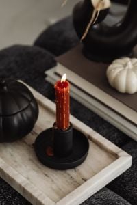 Kaboompics - Red Taper Candle on Tray With Black Pumpkin