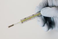 Kaboompics - Close-Up of Glass Thermometer Scale in a Gloved Hand, Fever Care Education