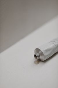 Kaboompics - UGC-Style Image of a Hand and Body Scrub Tube on a Neutral Background - Free Stock Photo