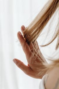 Kaboompics - Hand Lifting a Section of Long Hair for Inspection
