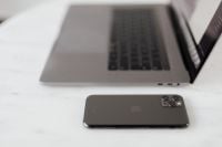 Kaboompics - MacBook Pro 15 laptop and iPhone 11 Pro on a marble table