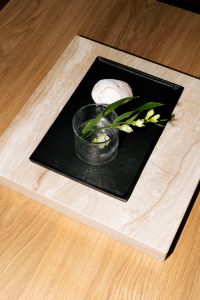 Kaboompics - Minimal Stone Tray With Glass And Flower On Coffee Table
