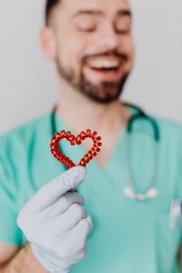 Kaboompics - Doctor Holding Heart-Shaped Medical Prop