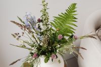 Kaboompics - Wildflower Bouquet in White Vase beside Upholstered Armchair