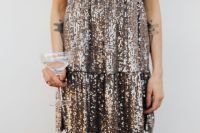 Kaboompics - Woman in Silver Sequin Dress Holding Champagne on White