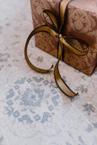 Kaboompics - elegantly wrapped gifts with golden ribbon