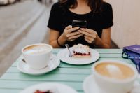 Kaboompics - The girl is using the phone in the cafeteria