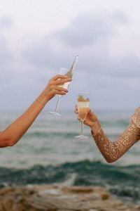 Kaboompics - Champagne Toast by the Sea with Sequin Dresses