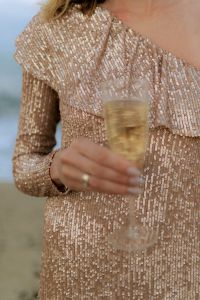 Kaboompics - Sequin Dress and Champagne Glass by the Sea