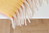 Kaboompics - Folded Yellow Blanket With Fringe
