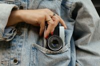 Kaboompics - Vintage Camera Tucked Into A Denim Jacket Pocket