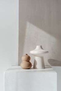 Kaboompics - Sculptural White and Beige Ceramic Vases in Sunlit Still Life