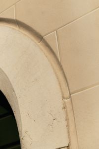 Kaboompics - Close-up of Stone Arch Keystone and Beige Tile Wall, Italy