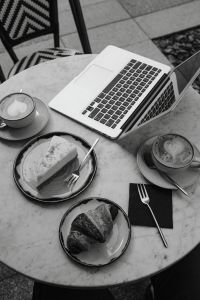 Kaboompics - Monochrome Coffee, Cake and Laptop Flat Lay