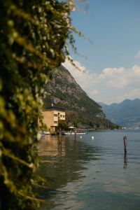 Kaboompics - Lake Iseo Shoreline Framed by Lush Green Foliage