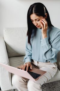 Kaboompics - Stressed Asian Woman Multitasking with a Laptop at Home