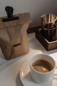 Kaboompics - Coffee Cup and Paper Coffee Bag Beside Pour-Over Dripper