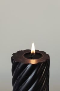 Kaboompics - Close-Up Black Candle Flame and Melted Wax, Minimal Neutral Background