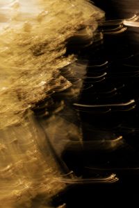 Kaboompics - Vertical Golden Motion Blur and Fine Light Trails beside Black Copy Space