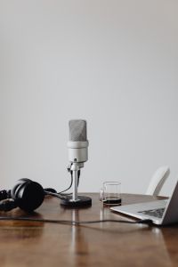 Kaboompics - Silver Microphone with Headphones and Coffee on Desk, Minimal Audio Setup