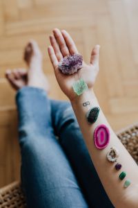 Kaboompics - Amethyst and Green Crystal Resting on an Open Palm, Minimal Wellness Still Life