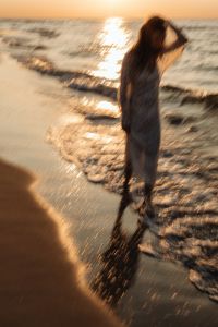 Kaboompics - Woman Standing on Shore at Golden Hour