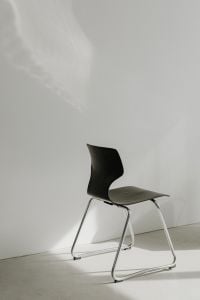 Kaboompics - Dark Sculptural Chair in Bright Neutral Room
