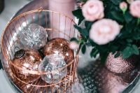 Kaboompics - Rose Gold Christmas Ornaments in a Wire Basket with Pink Flowers