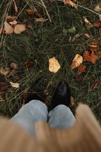 Kaboompics - Black Ankle Boots Standing on Autumn Grass and Leaves