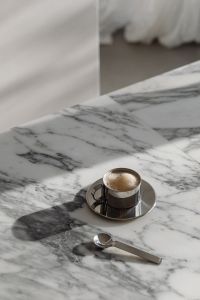 Kaboompics - Chrome Coffee Cup and Spoon on Arabescato Marble