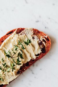 Kaboompics - Hummus Toast with Thyme and Marble Copy Space