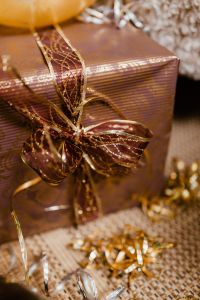 Kaboompics - Vertical Gold Wrapped New Year's Eve Gift with Oversized Mesh Ribbon Bow
