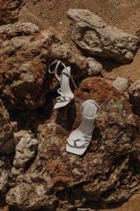 Kaboompics - White Ankle-Strap Heels Styled Between Rocky Tide Pools