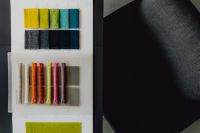 Kaboompics - Colorful Upholstery Samples Beside a Curved Gray Chair in a Modern Design Studio