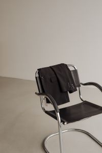 Kaboompics - Black Blazer Draped on Chrome Chair in Minimal Interior