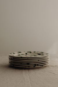 Kaboompics - Green Splatter Plate Stack with Tall Neutral Background