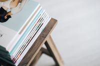 Kaboompics - Stack of magazines on the wooden stool