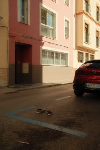 Kaboompics - Wide Street Scene with Pink Apartment Facade and Abandoned Sneakers