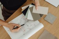 Kaboompics - Interior Designer Matching Finish Samples to an Architectural Floor Plan