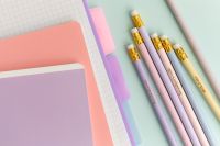 Kaboompics - Pastel Notebook Stack with Pencils