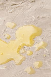 Kaboompics - Yellow Cream on Textured White Background