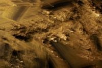 Kaboompics - Golden Light Streaks and Pale Highlights on Dark Brown, Abstract Background Texture