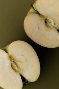 Kaboompics - Close Up of Sliced Apple on Olive Green Background