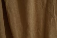 Kaboompics - Warm Taupe Curtain Fabric with a Single Deep Fold, Abstract Background