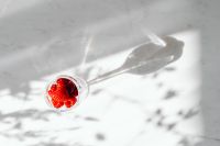 Kaboompics - Raspberry Glass And Long Shadow Top View