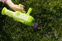 Kaboompics - Lime Green Bubble Blaster over Grass with Purple Flowers